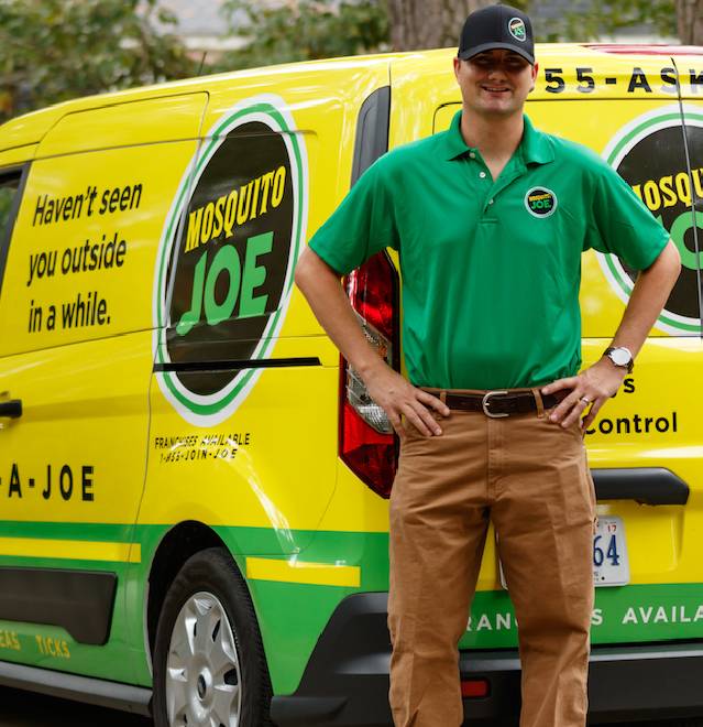 Mosquito Joe professional standing in front of van.