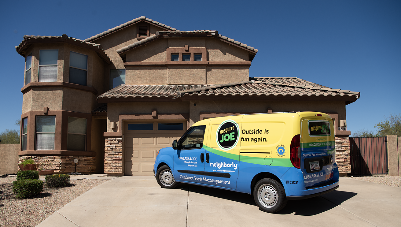 Mosquito Joe van in front of a house.